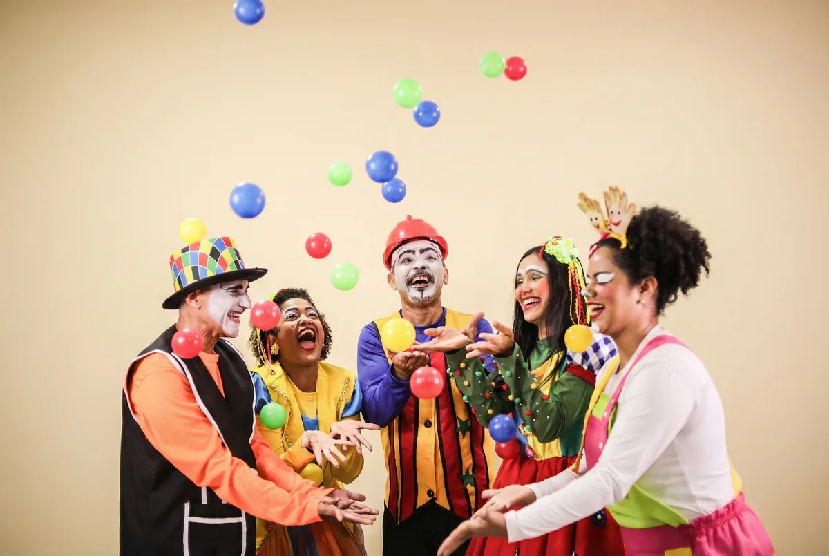 Theatrical performance on stage with colorful lighting, dancers in artistic costumes, dramatic cultural event